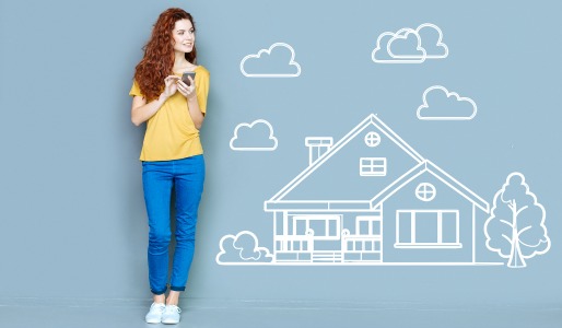 young woman with mobile device house drawing